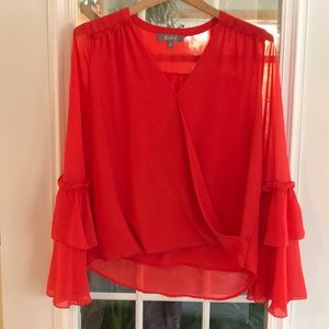 Orange flowy top with fun ruffled sleeves